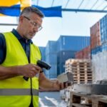 Warehouse manager scanning industrial parts inventory