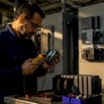 Engineer inspecting RX7i PLC in control room