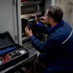 Technician replacing RX3i PACSystems GE PLC module
